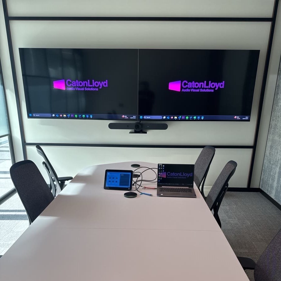 Twin screens with a control panel in a small meeting room in CoStar Groups London office