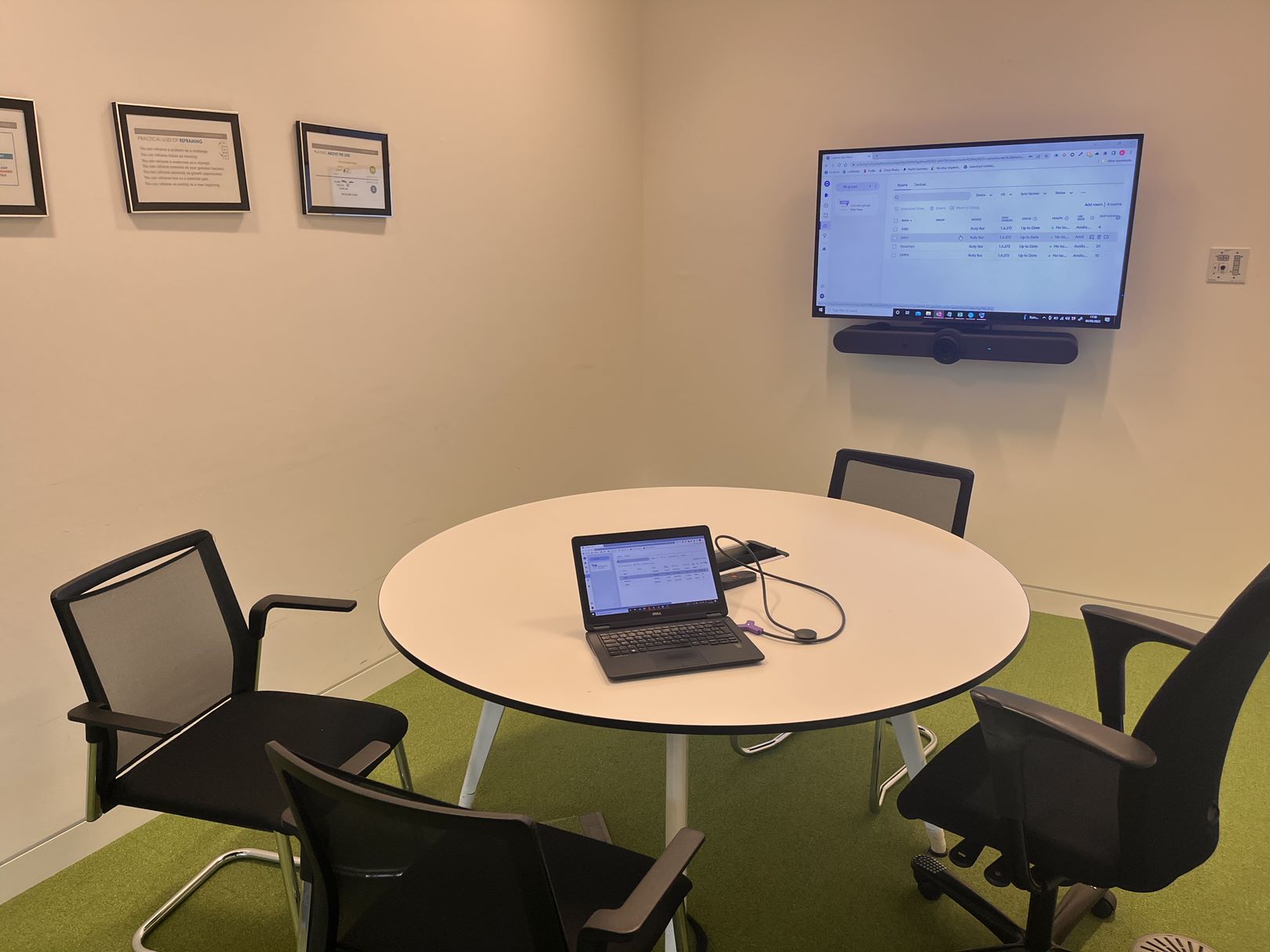 Large display screens installed inside of small meeting room.