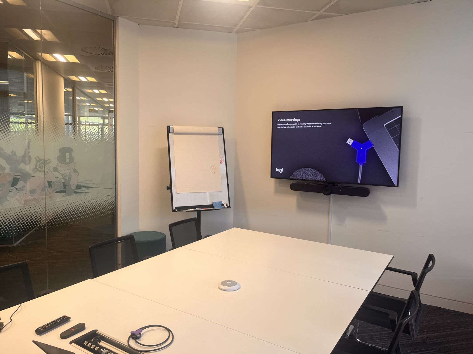 Meeting room featuring large screen with Logitech soundbar.