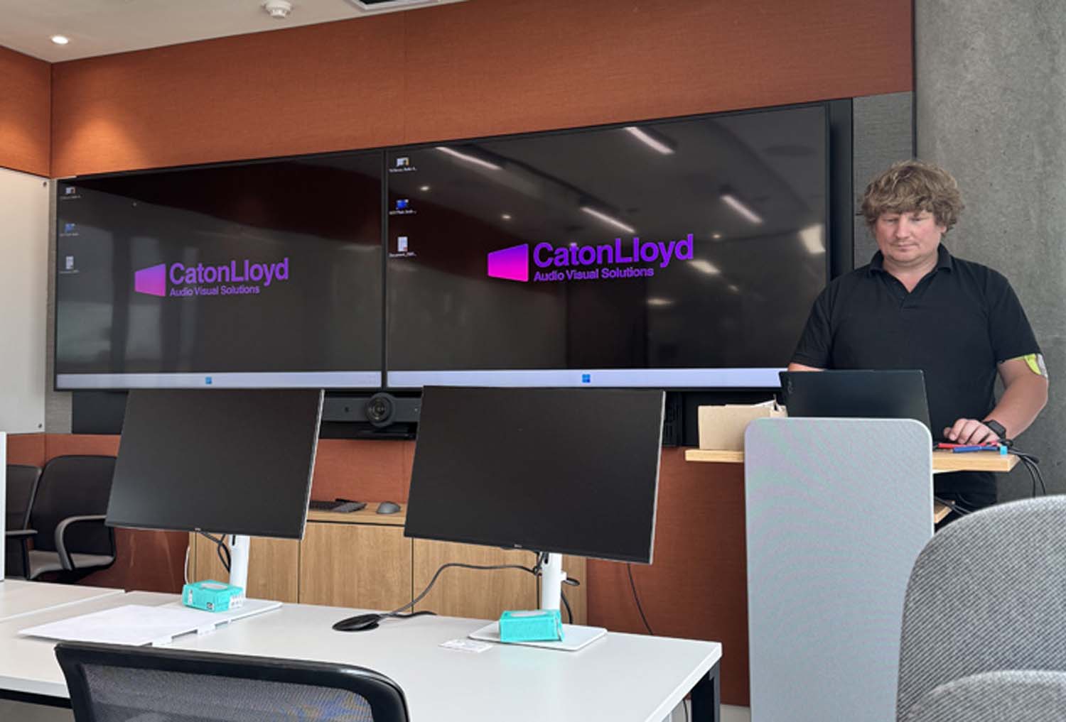 CatonLloyd audio visual engineer maintaining twin screens at london office.