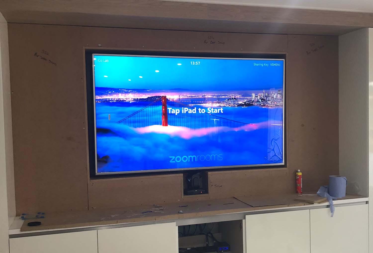 Specialist joinery Zoom room monitor installed by CatonLloyd against meeting room wall.