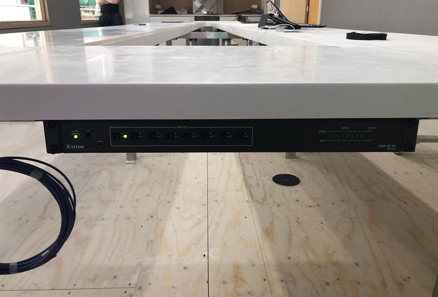 Zoom room installation featuring under table mounted electronics.